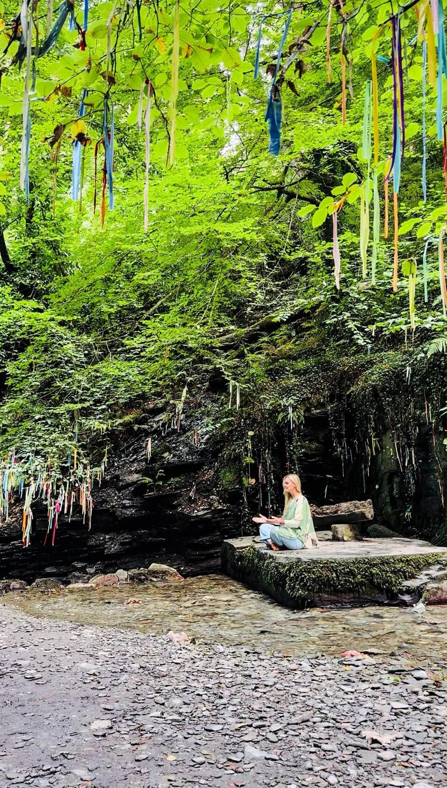 Clootie ribbons hanging from the trees above the stone platform at St Nectan's Glen